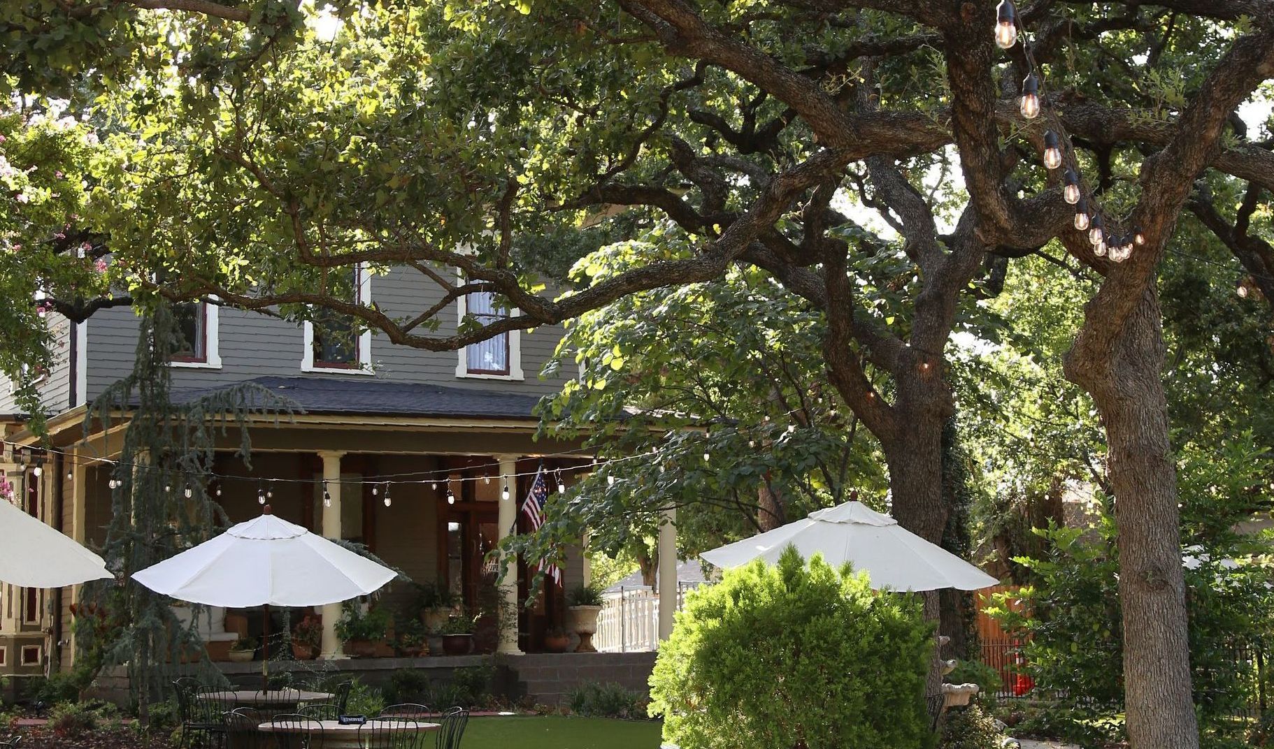 A house with white umbrellas in front of it