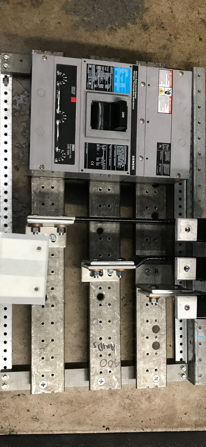 Circuit breaker mounted on metal supports.