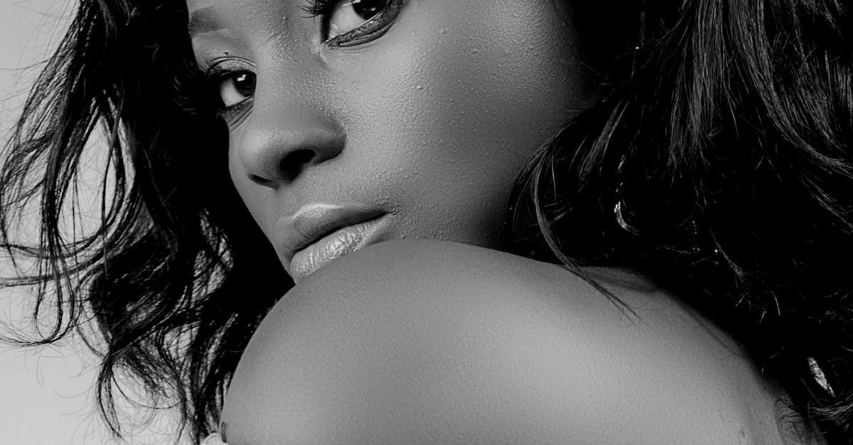 A black and white photo of a woman looking over her shoulder.