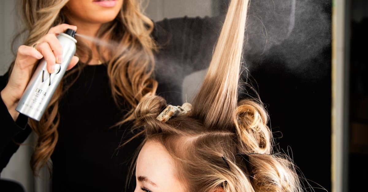 A woman is getting her hair done by a hairdresser.