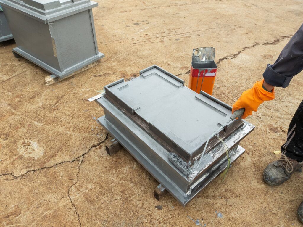 A Person Wearing Orange Gloves is Holding a Metal Object — A1 Maintenance and Building In Old Bar, NSW