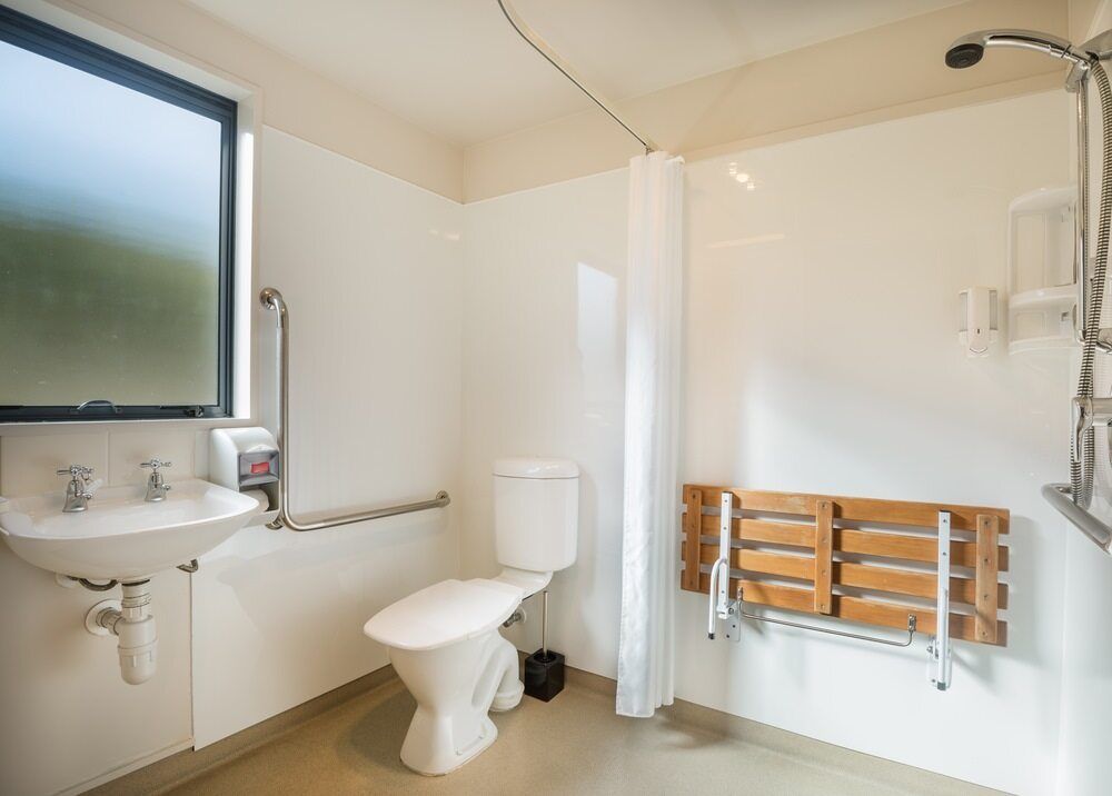 A Bathroom With a Toilet, Sink and Shower — A1 Maintenance and Building In Old Bar, NSW