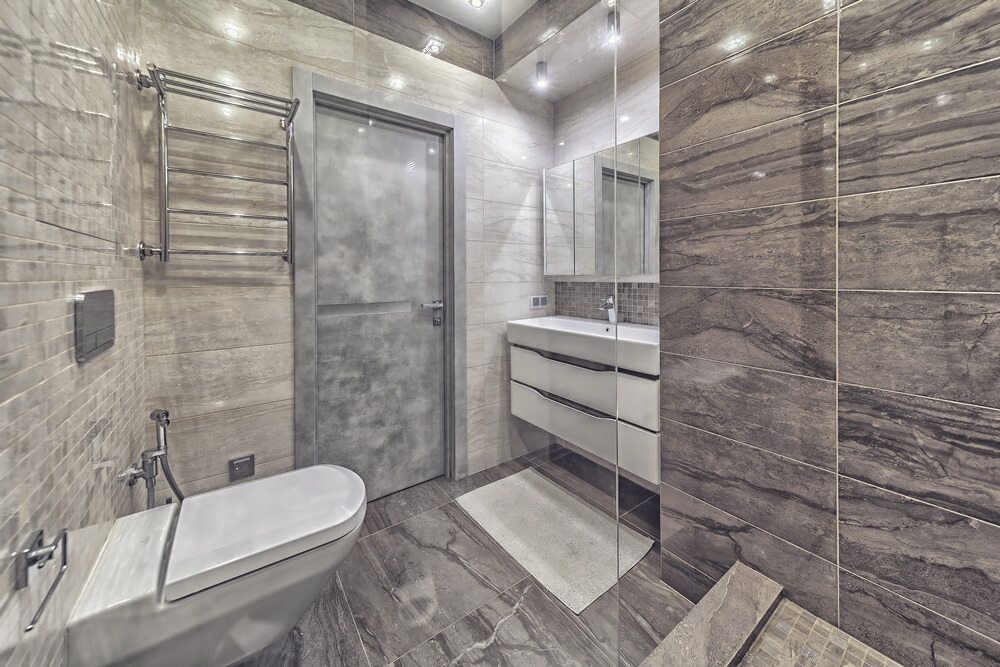 A Bathroom With a Toilet, Sink, and Walk in Shower — A1 Maintenance and Building In Old Bar, NSW