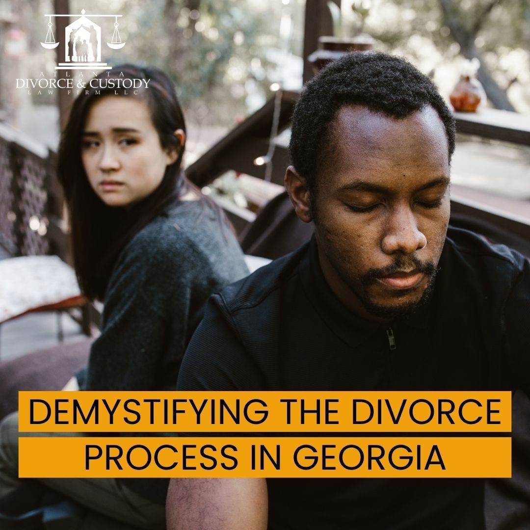 A man and a woman sitting back to back with the words demystifying the divorce process in georgia