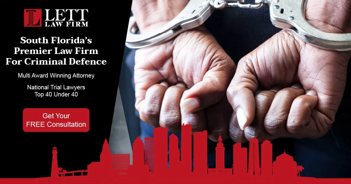 A man in handcuffs is standing in front of a city skyline.