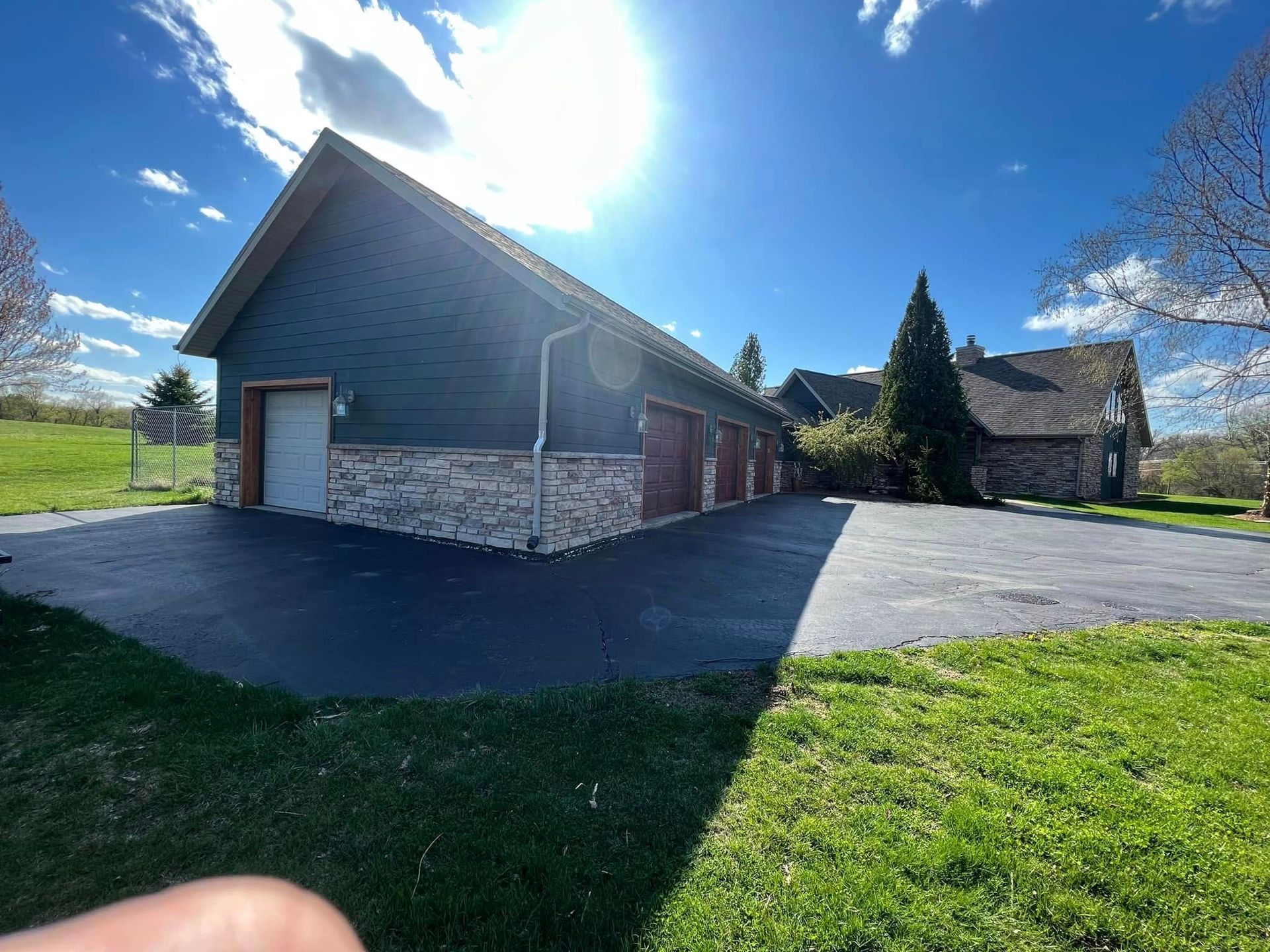 A large house with a lot of garages and a driveway.