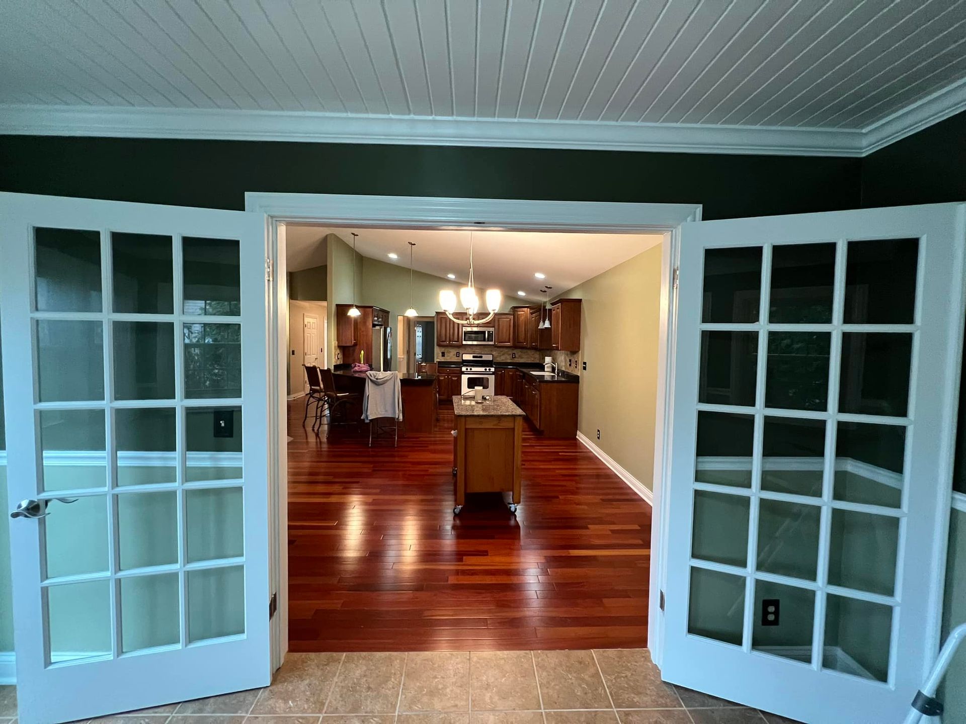 A kitchen and dining room are connected by french doors