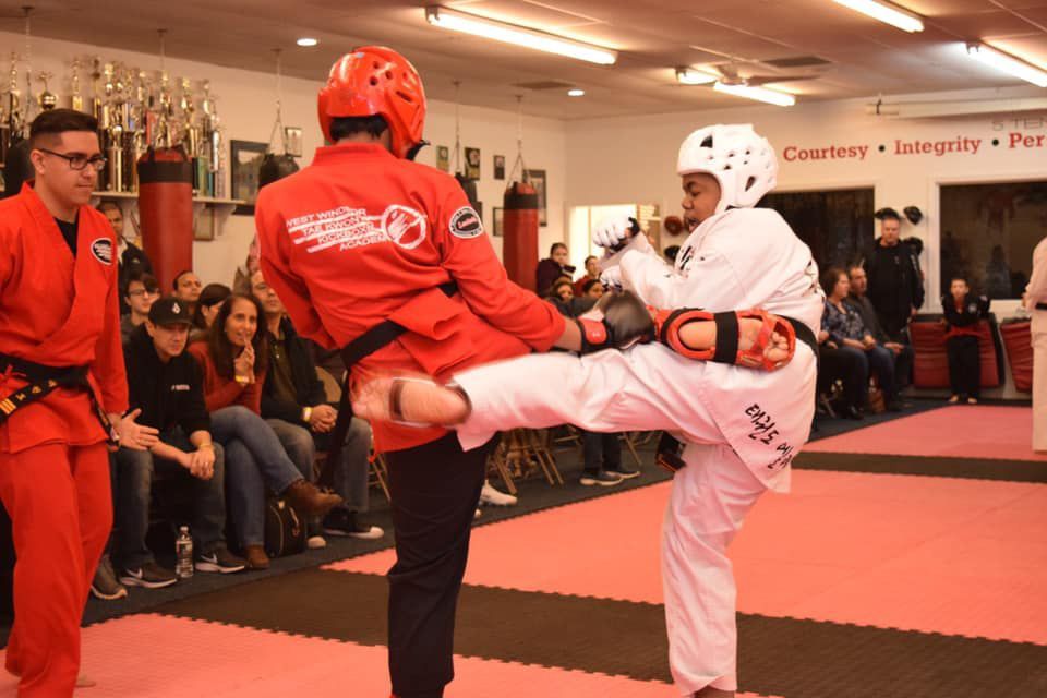 two fighters kicking each other