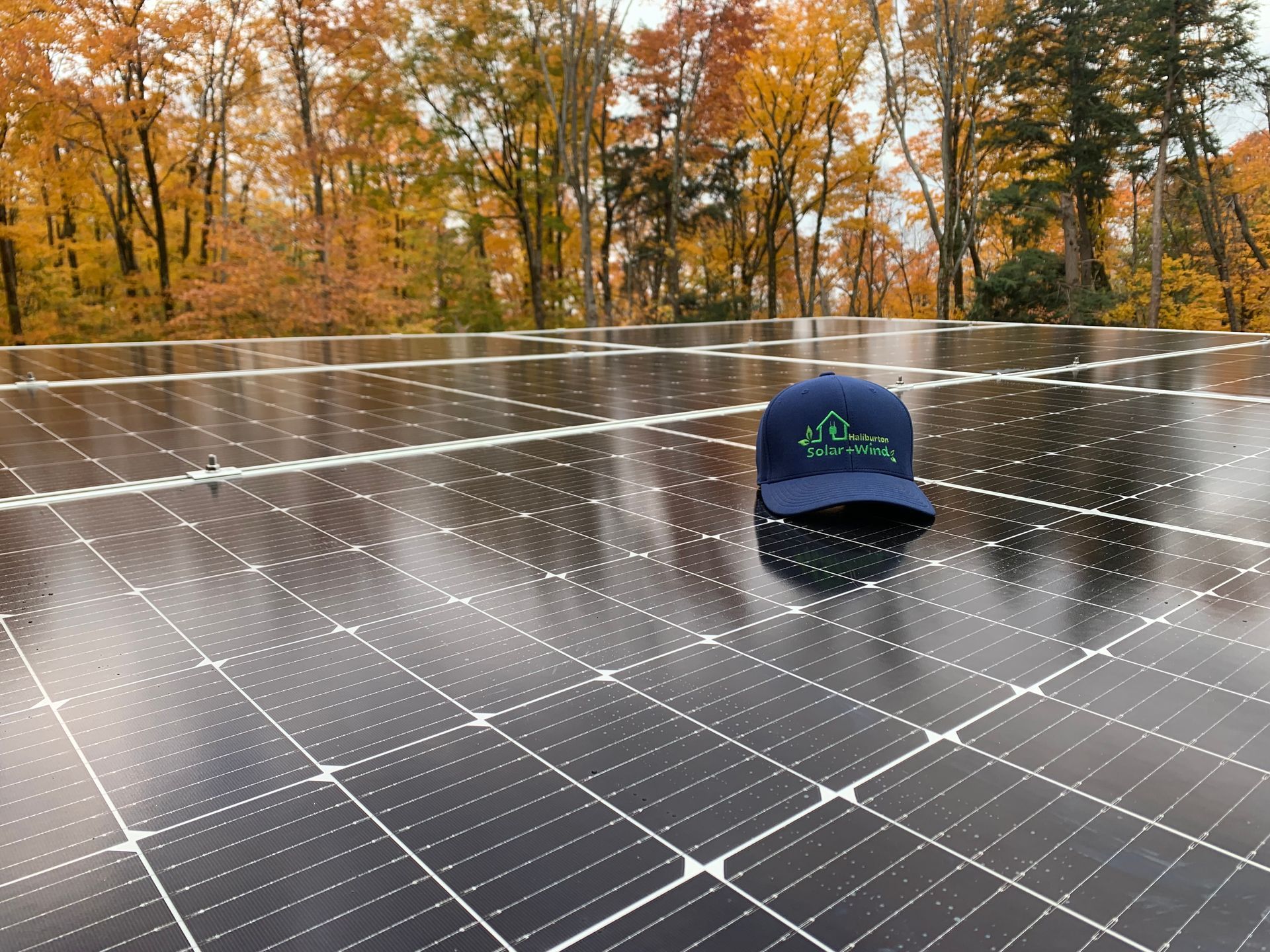 A blue hat is sitting on top of a solar panel.
