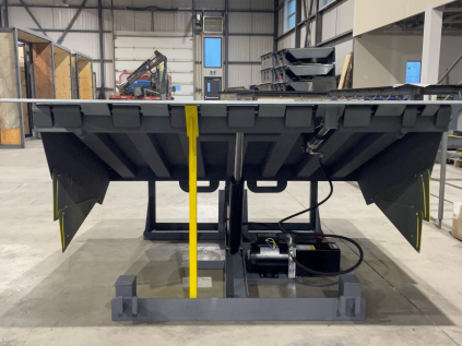 A machine is sitting on a concrete floor in a warehouse.