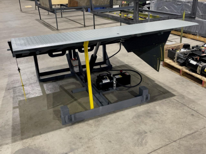 A machine is sitting on a concrete floor in a warehouse.