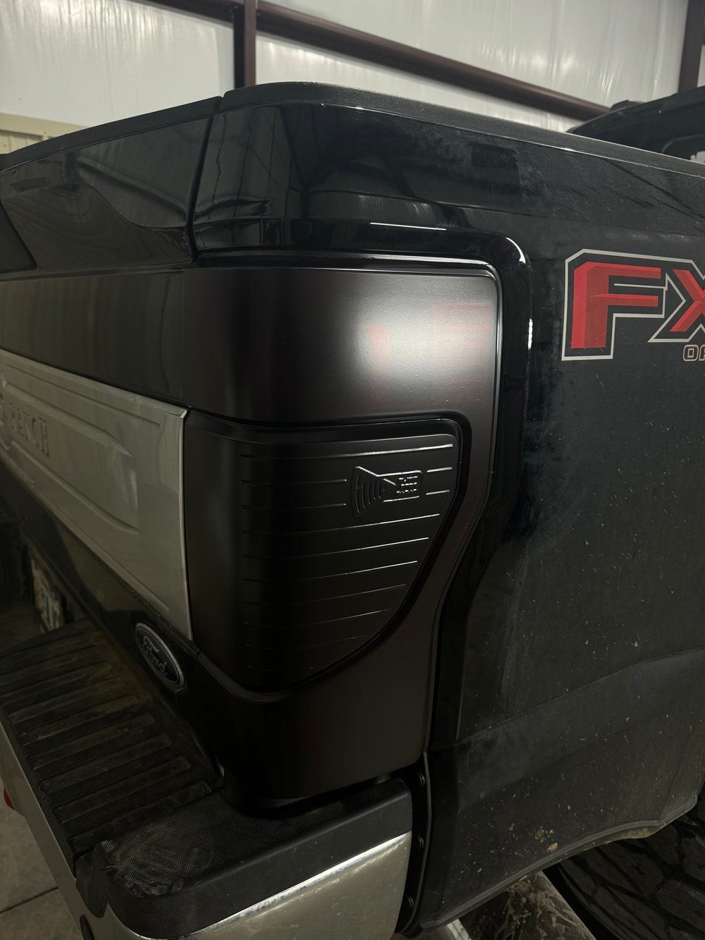 Black Ford F-150 truck tail light assembly with tinted lens and 