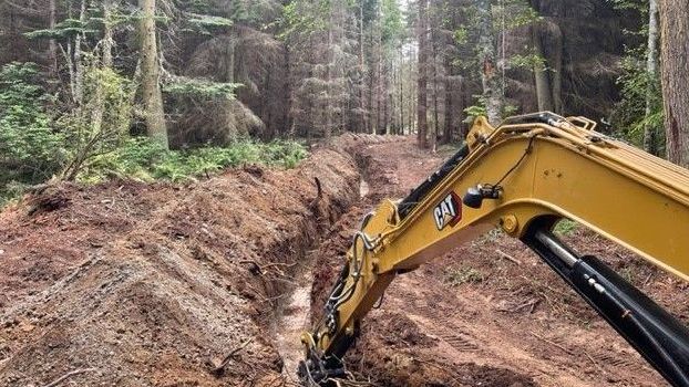 Land clearing and utilities preparation for home building site.