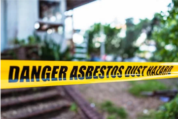 A yellow tape that says danger asbestos dust hazard