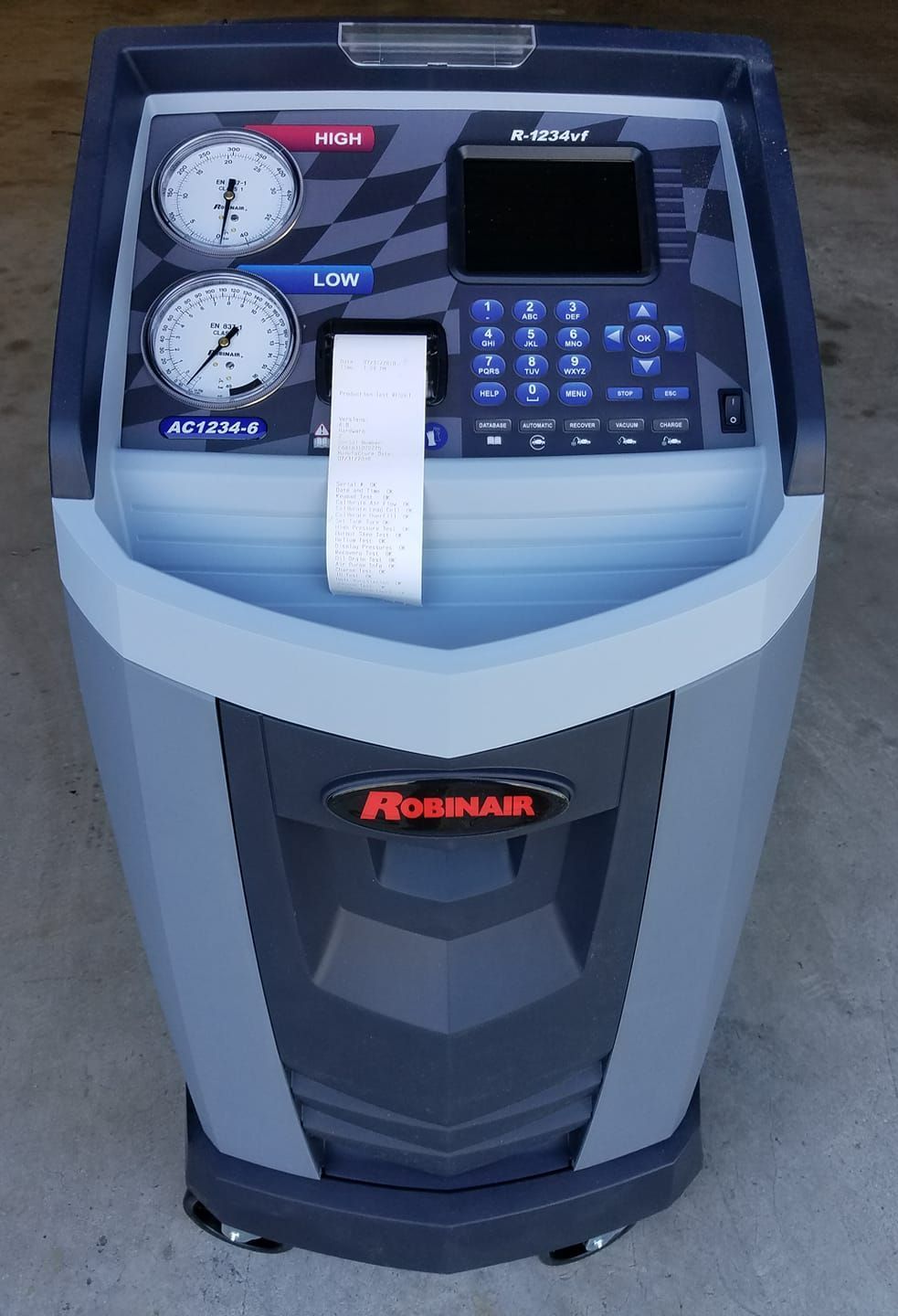 A roomair air conditioning machine is sitting on the ground