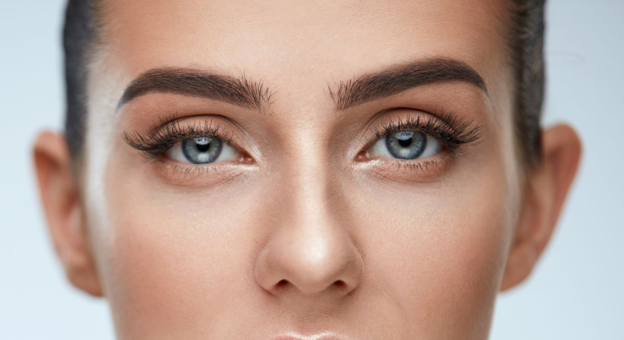 Woman with dark wavy hair and subtle makeup, looking away. Woman with dark wavy hair and subtle makeup, looking away.