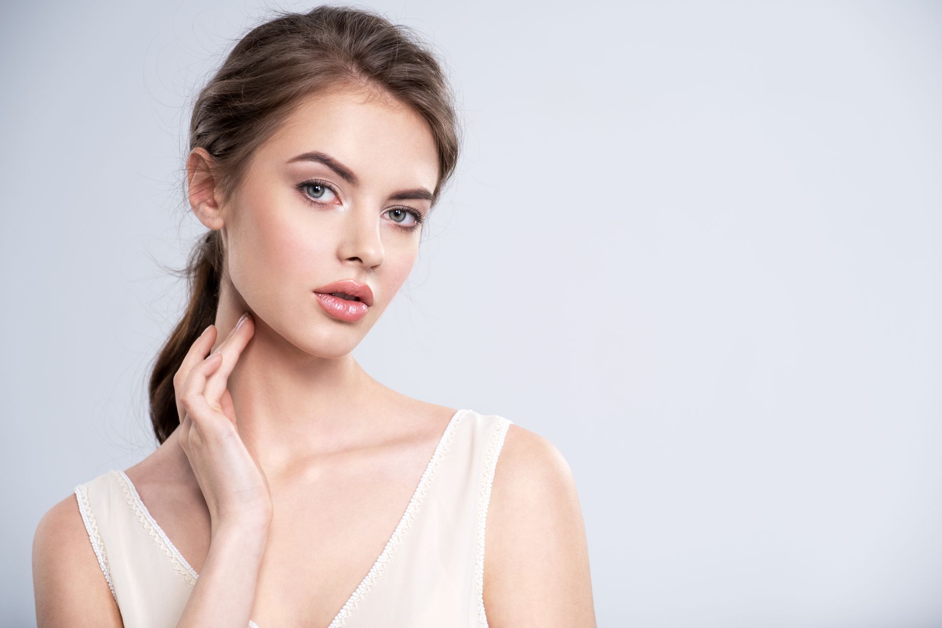 Woman with dark wavy hair and subtle makeup, looking away. Woman with dark wavy hair and subtle makeup, looking away.