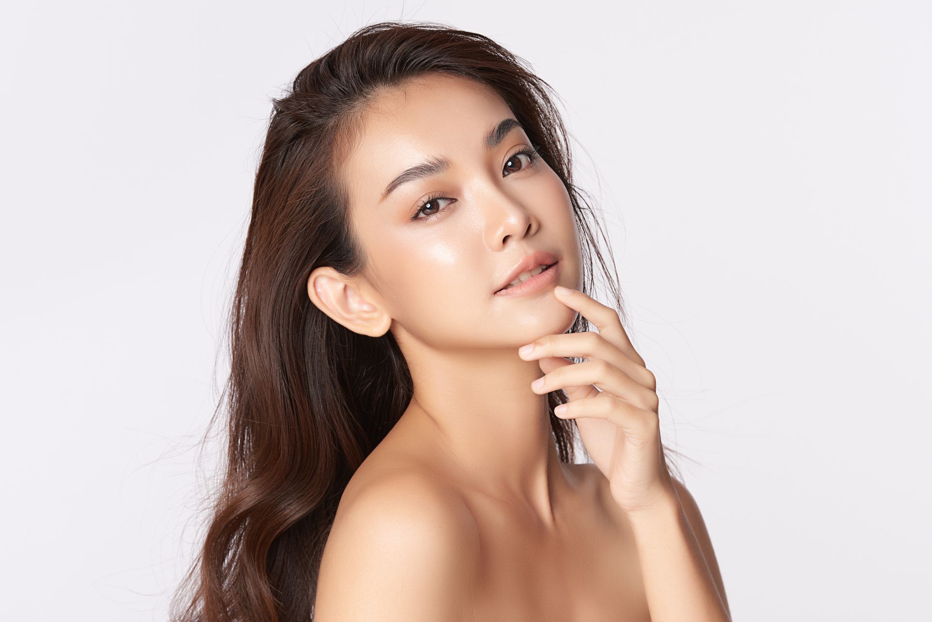 Woman with dark wavy hair and subtle makeup, looking away. Woman with dark wavy hair and subtle makeup, looking away.