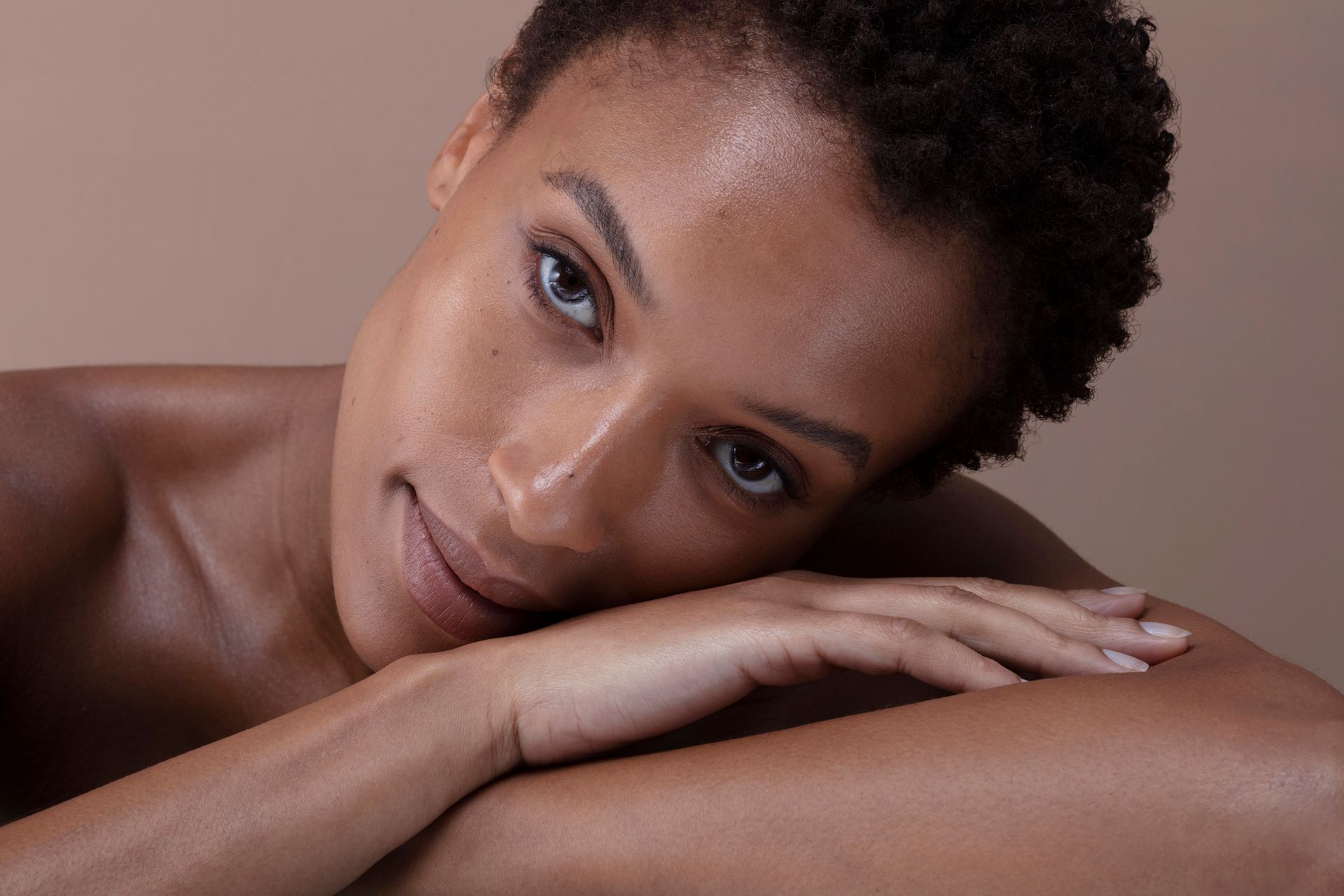 Woman with dark wavy hair and subtle makeup, looking away. Woman with dark wavy hair and subtle makeup, looking away.
