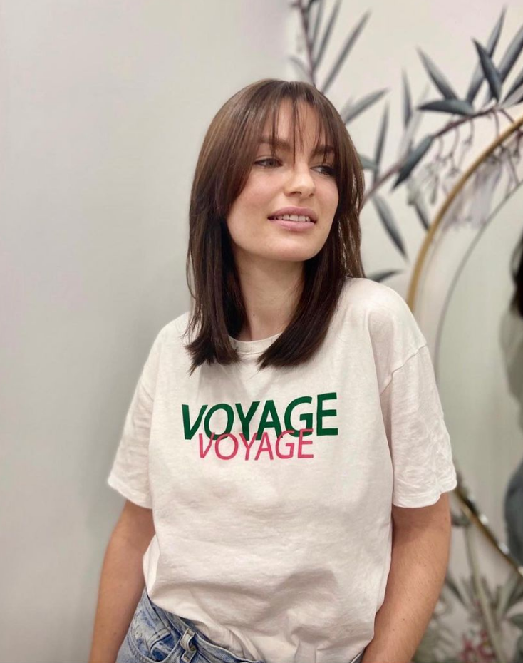 Femme aux cheveux bruns dégradés, avec frange,