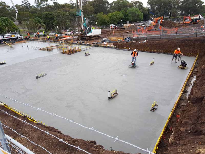 concrete workers smoothing concrete