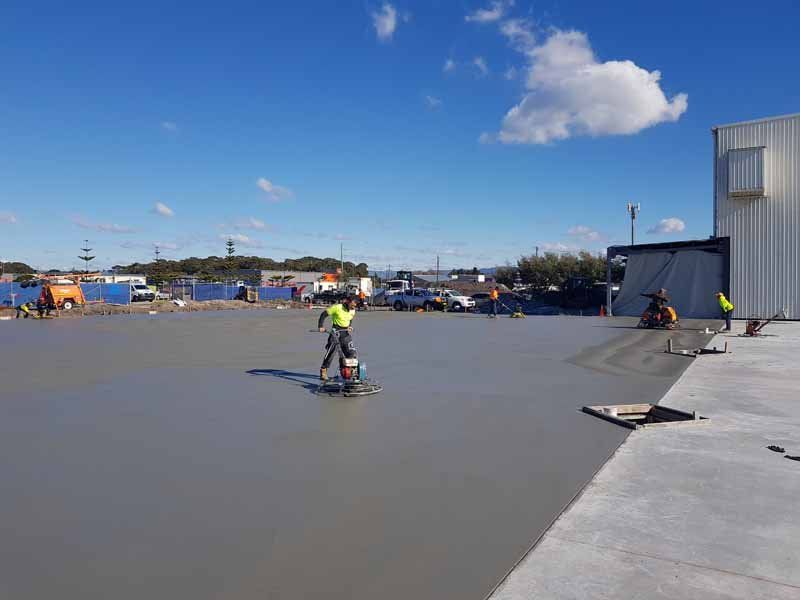 worker smoothing concrete