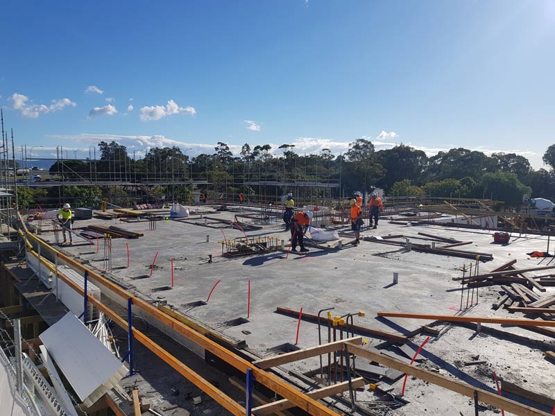 concrete workers on construction site