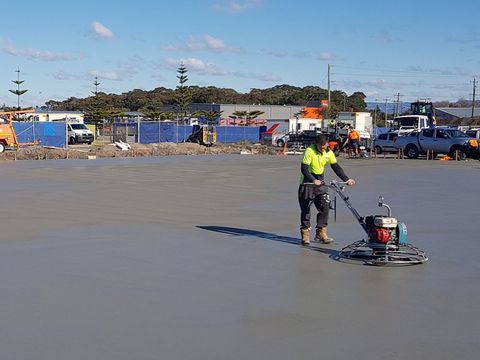 concrete worker smoothing concrete