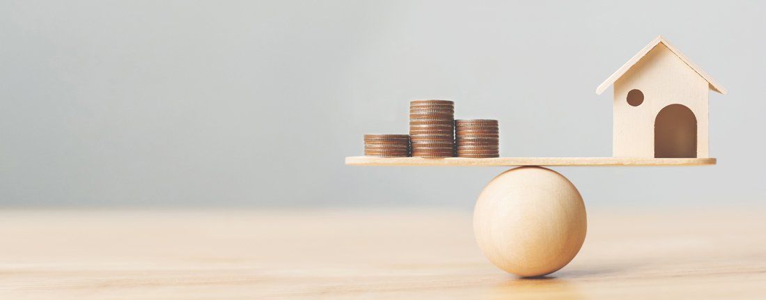 Wooden Home and Money Coins Stack on Wood Scale — Fort Smith, AR — ASAP Insurance