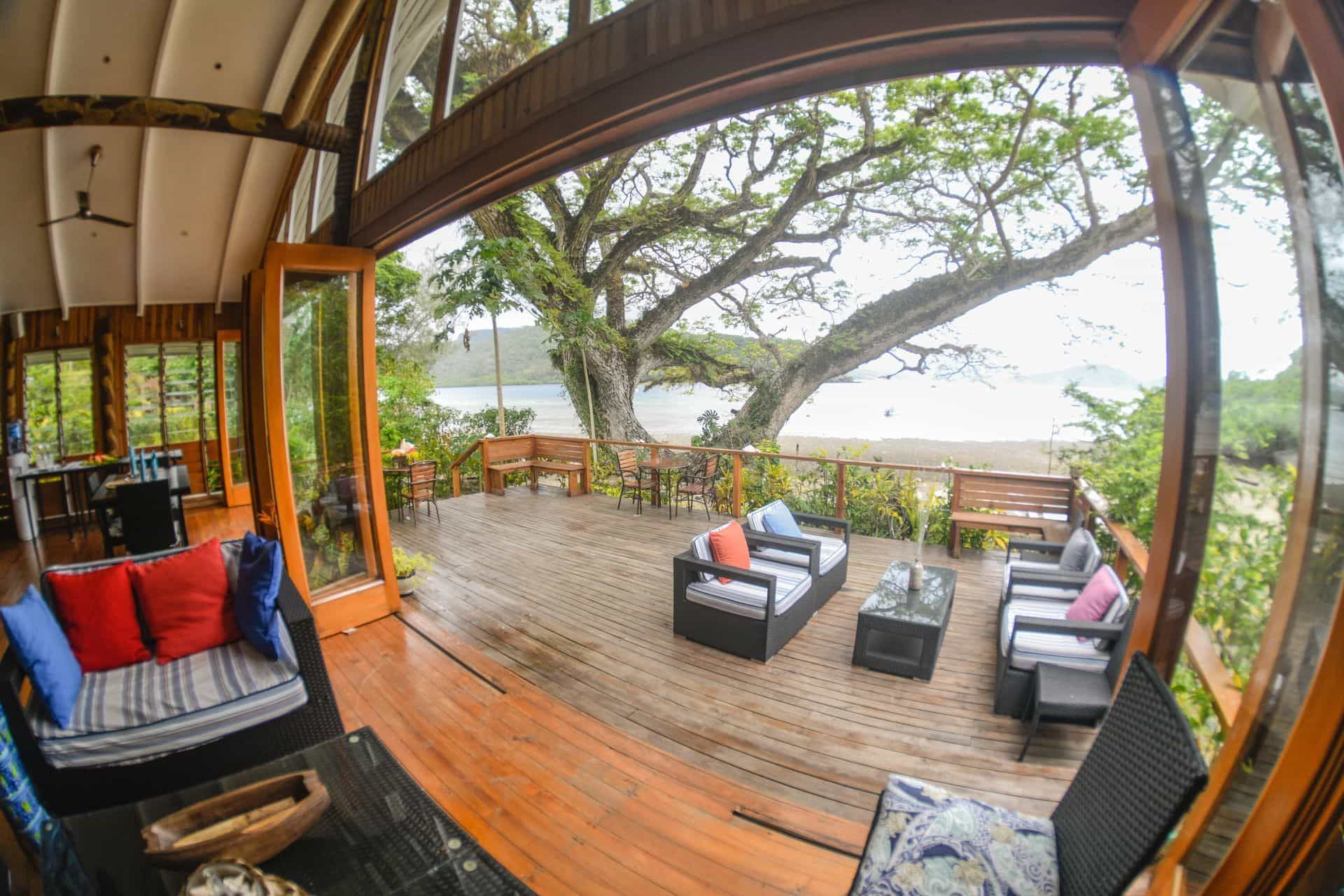 Wooden sliding doors and seating area on the drinks  and restaurant verandah at Sau Bay Resort Fiji 
