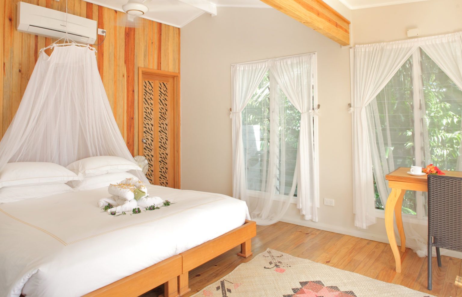 A double bed in a light and airy deluxe beach front bure at Sau Bay  Resort Fiji 