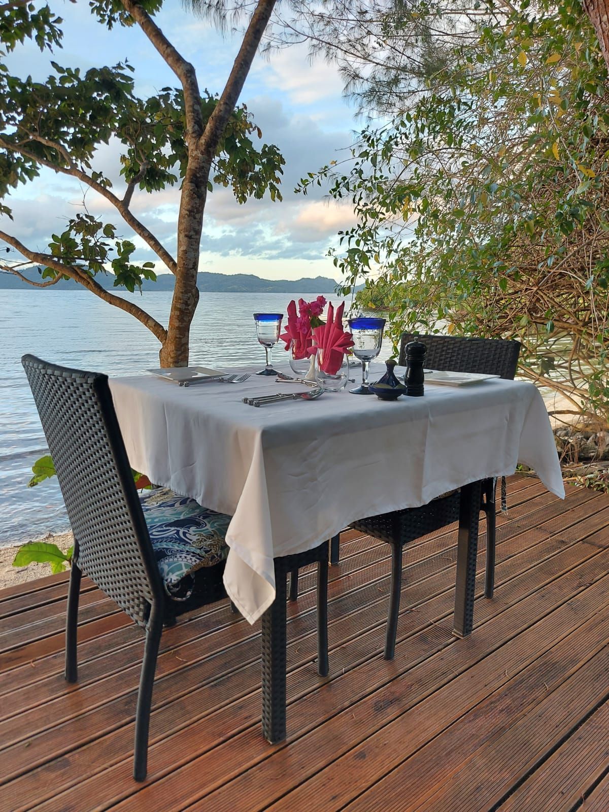 A table laid for two to dine at the water's front under the stars at Sau Bay resort in Fiji 