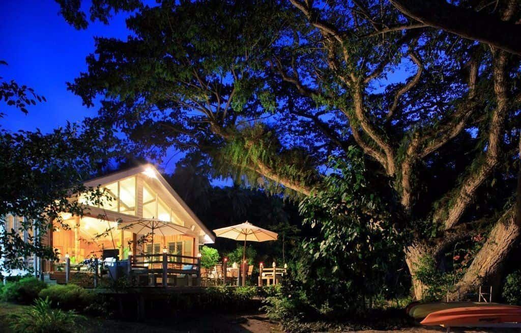 The communal dining and bar area at Sau Bay  under the resort trees by night