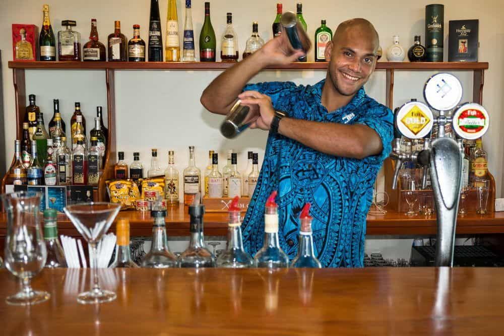 A bar man shaking a delicious cocktail at the sand bar at Volivoli Beach Resort in Fiji