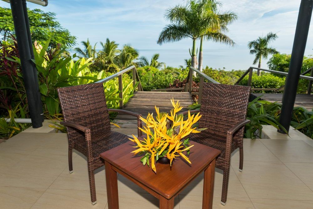 Yellow Flowers decorate the outdoor seating area in front of the ocean at Volivoli Beach Resort, Fiji 