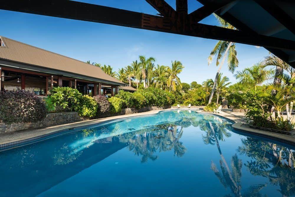 Shadows made by tropical trees across the swimming pool at Volivoli Beach Resort in Fiji, where you can find the best scuba diving