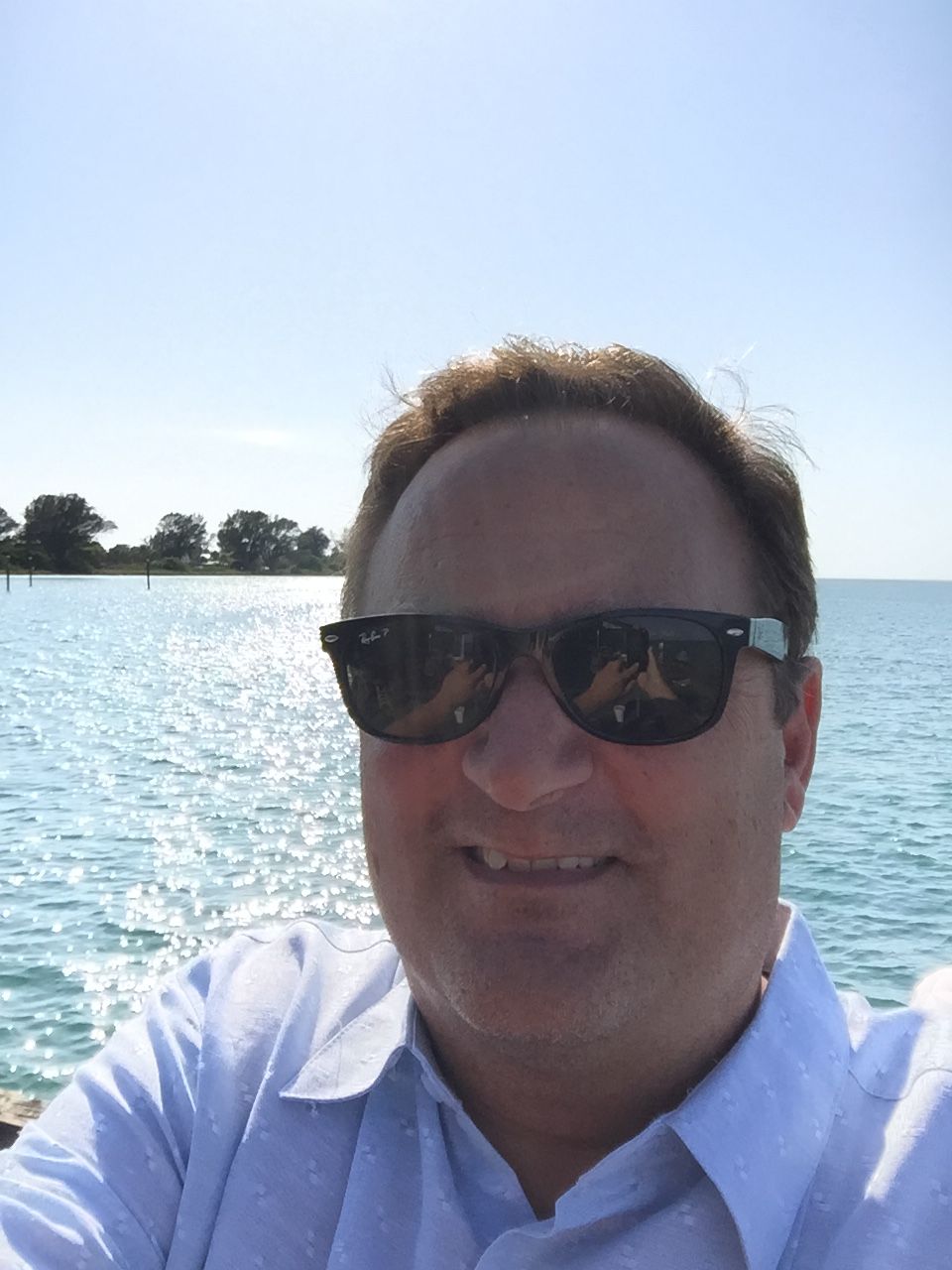 A black and white photo of a silhouette of a man standing in front of a wall.