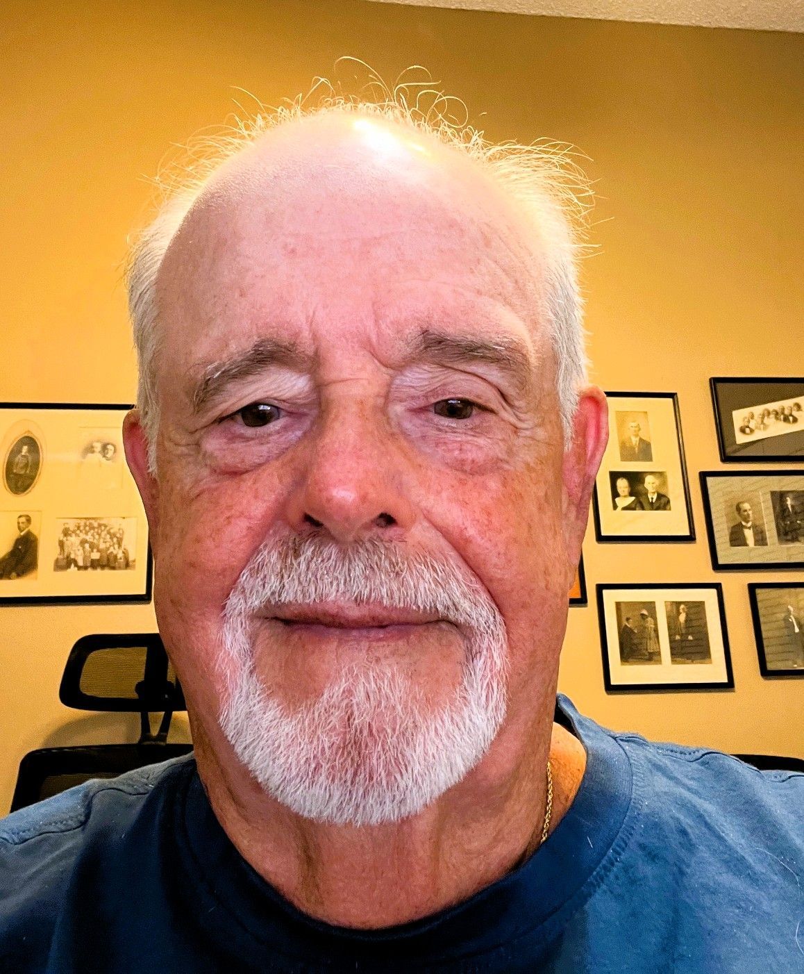 A black and white photo of a silhouette of a man standing in front of a wall.