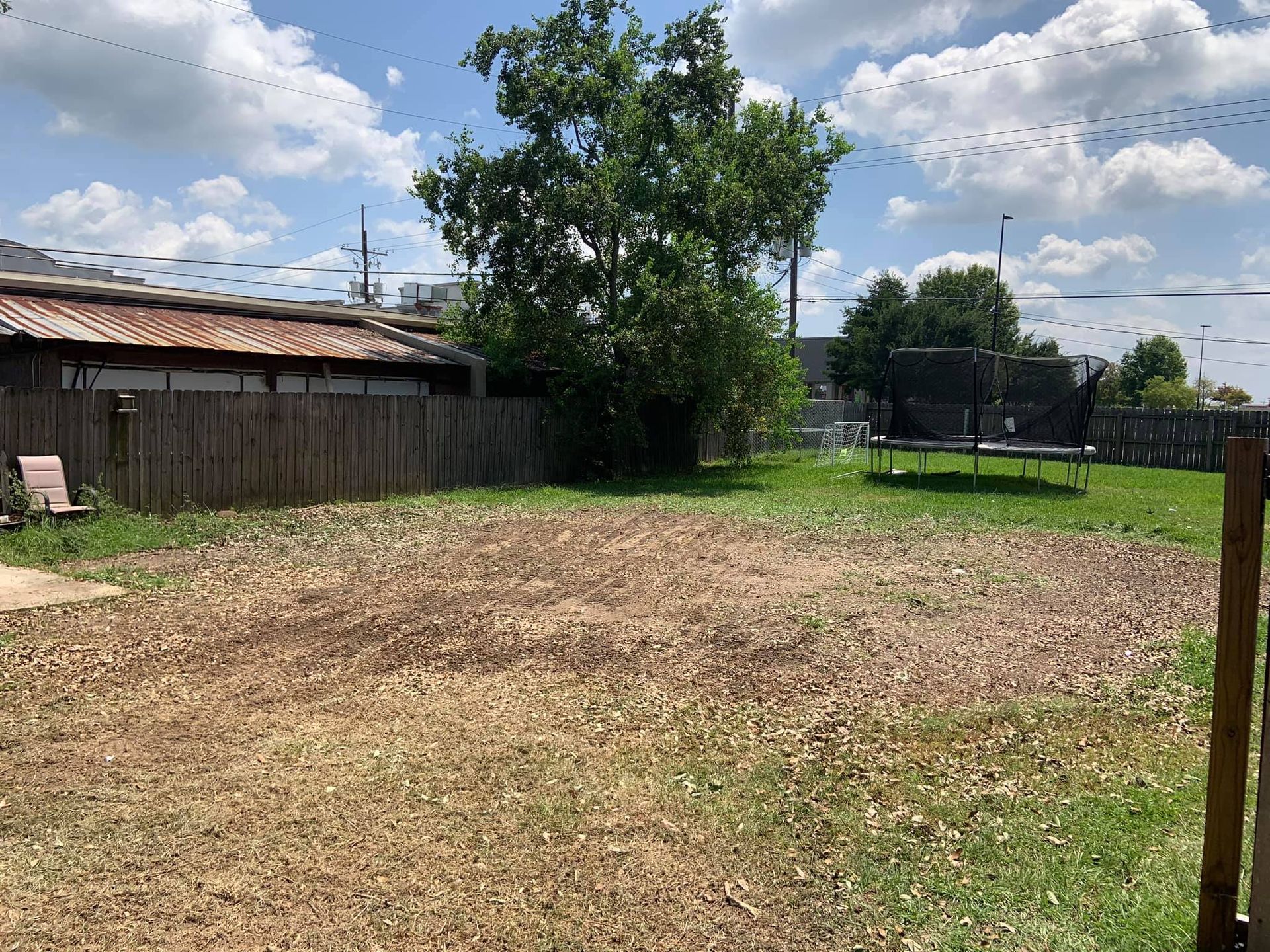 There is a trampoline in the backyard of a house.