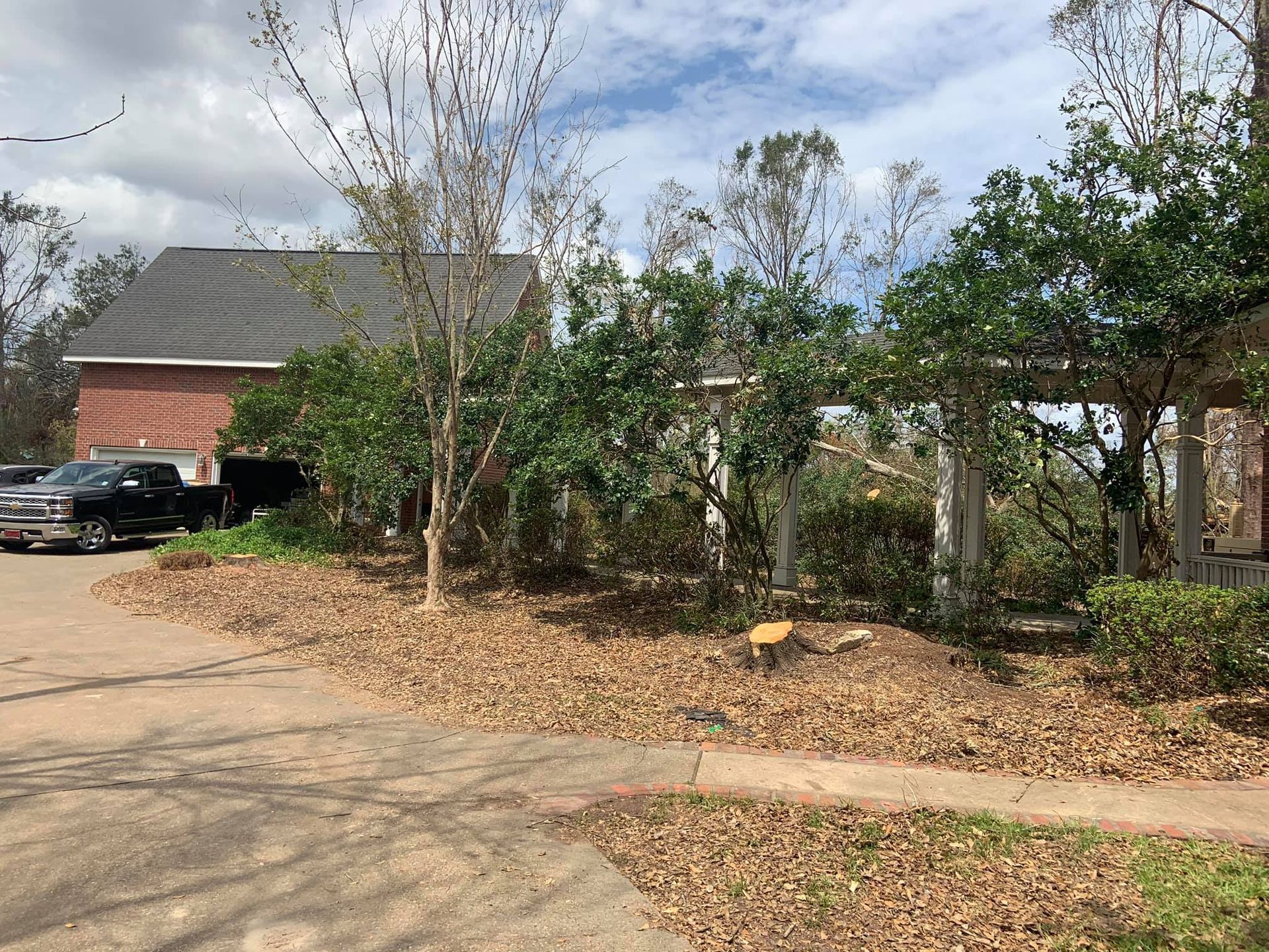 A black truck is parked in front of a house.