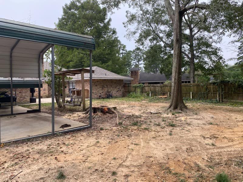 There is a carport in the backyard of a house.