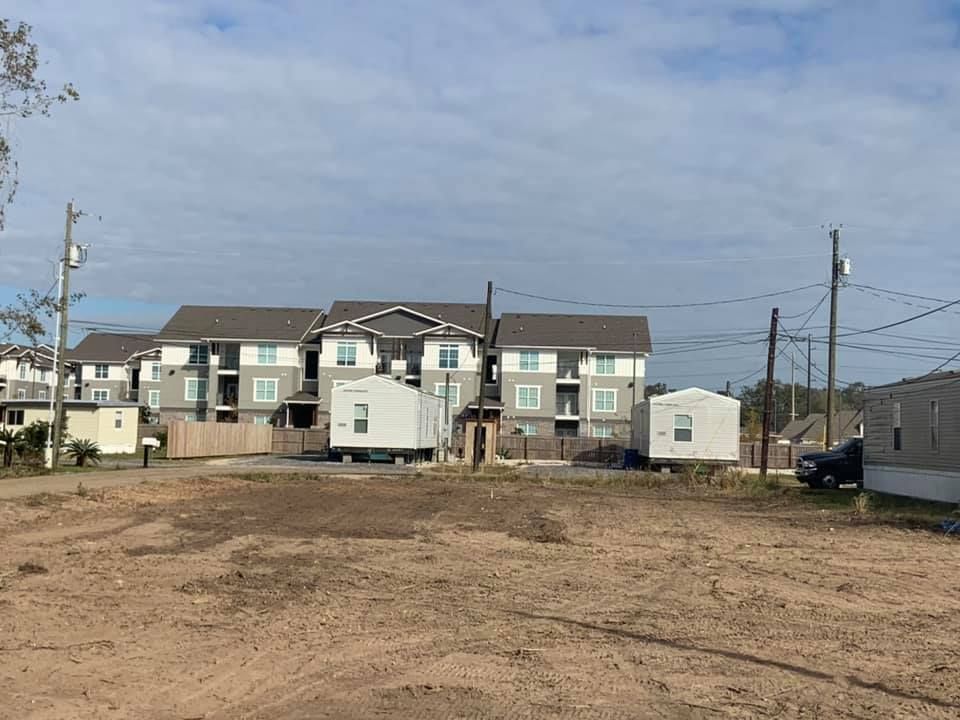 There is a lot of dirt in the foreground and a building in the background.