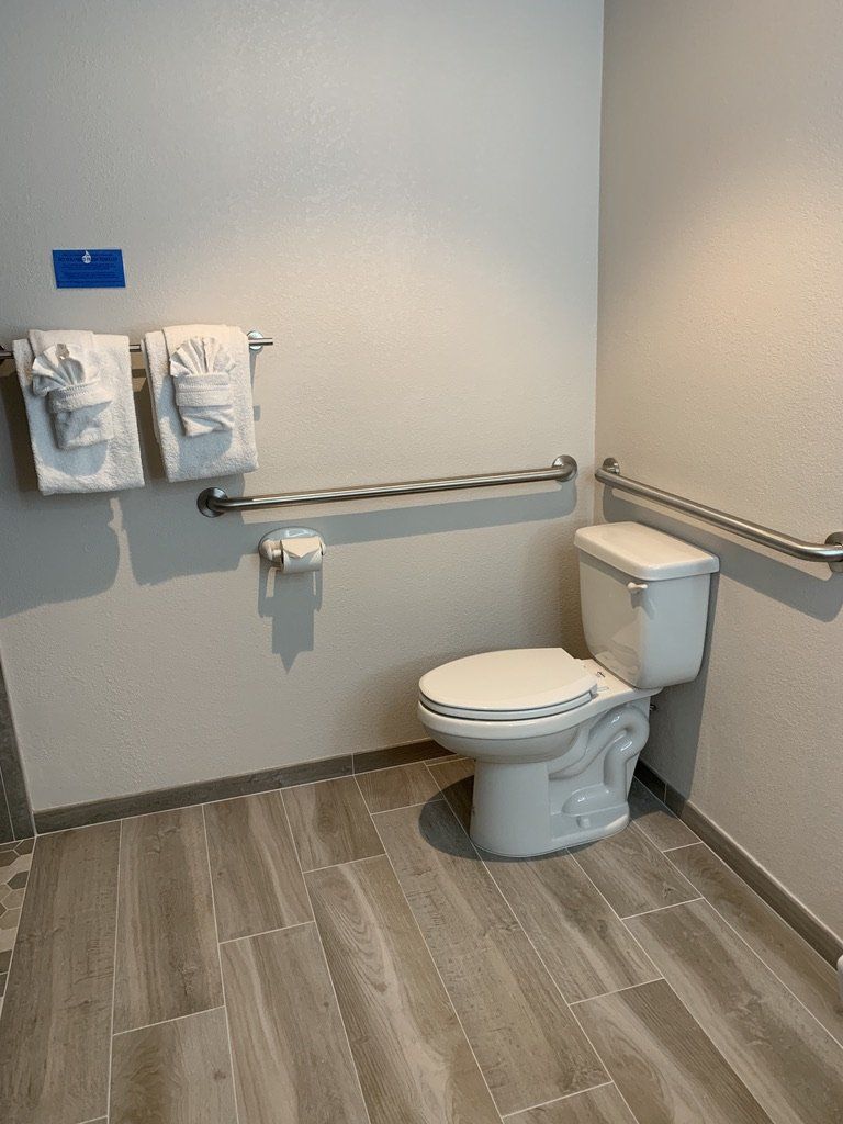 Wheel Chair Accessible Toilet with hand rails.