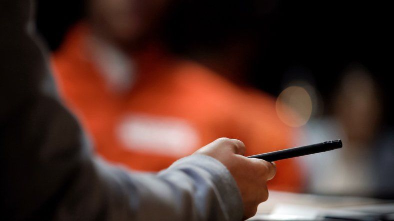 Woman police officer making notes on witness statement