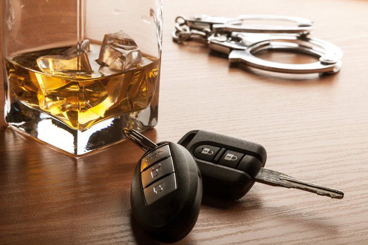 Alcoholic drink, keys, and handcuffs