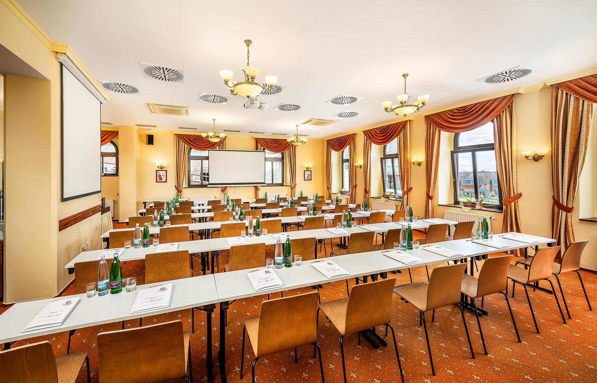 Velká místnost se stoly a židlemi a stropem s potiskem zebry