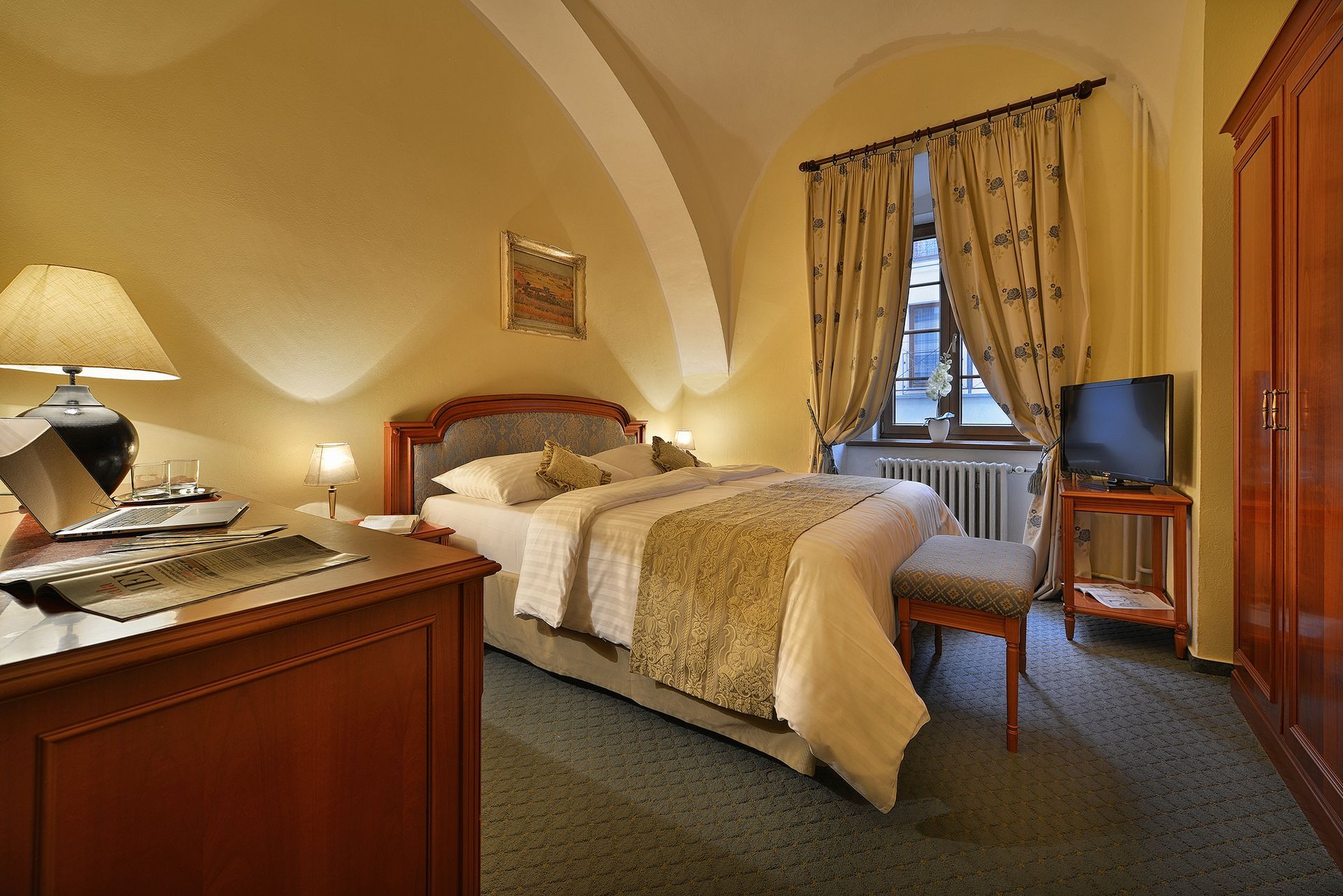 Hotelový pokoj s velkou postelí a televizí