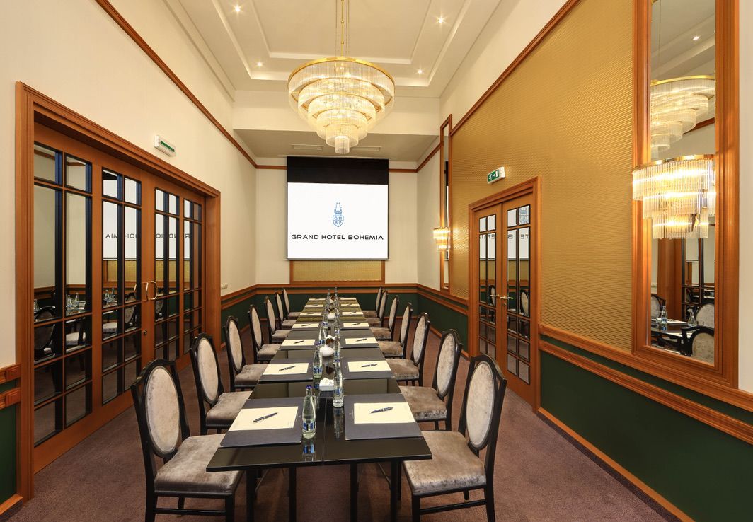 Konferenční místnost s dlouhým stolem a židlemi