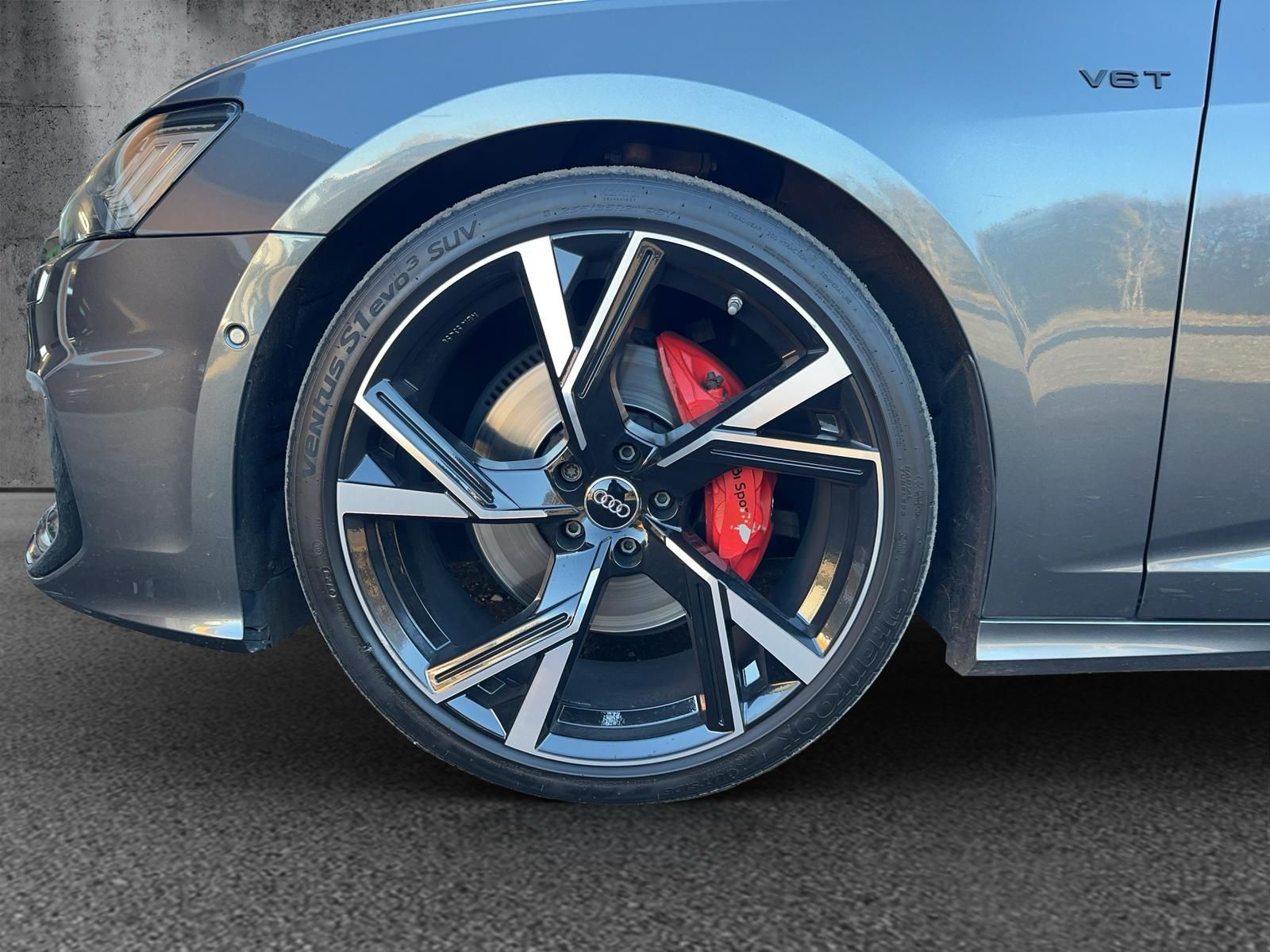 Eine Nahaufnahme eines Autorads mit roten Bremssätteln