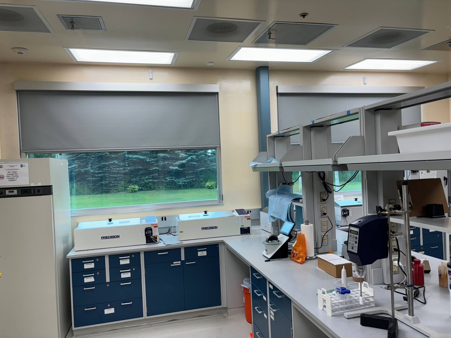 Sleek and efficient commercial window treatments, half opened, on large windows in a medical facility near Anchorage, AK